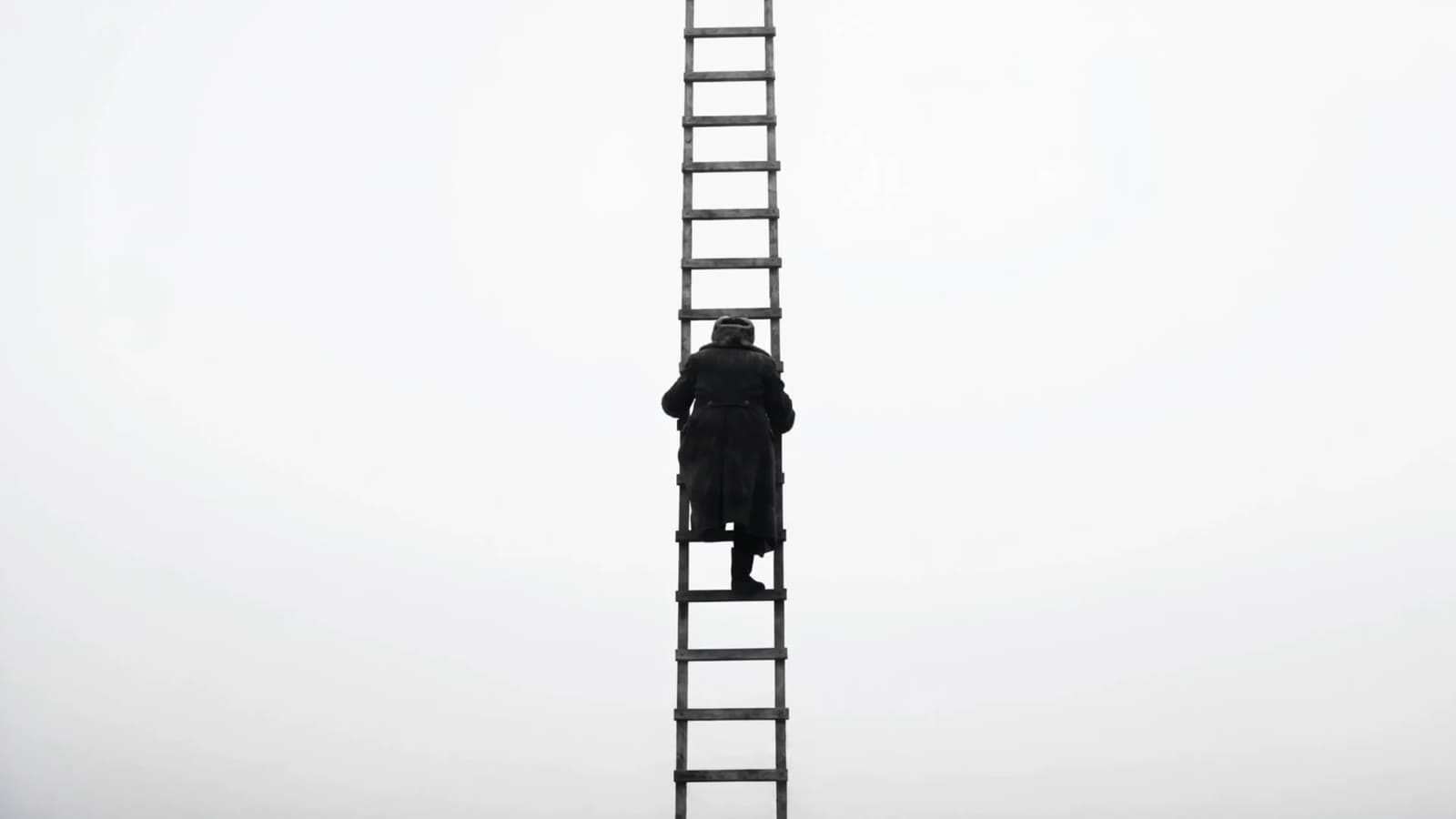 A lone figure climbing a ladder into white fog — a still from the Tellacora launch film